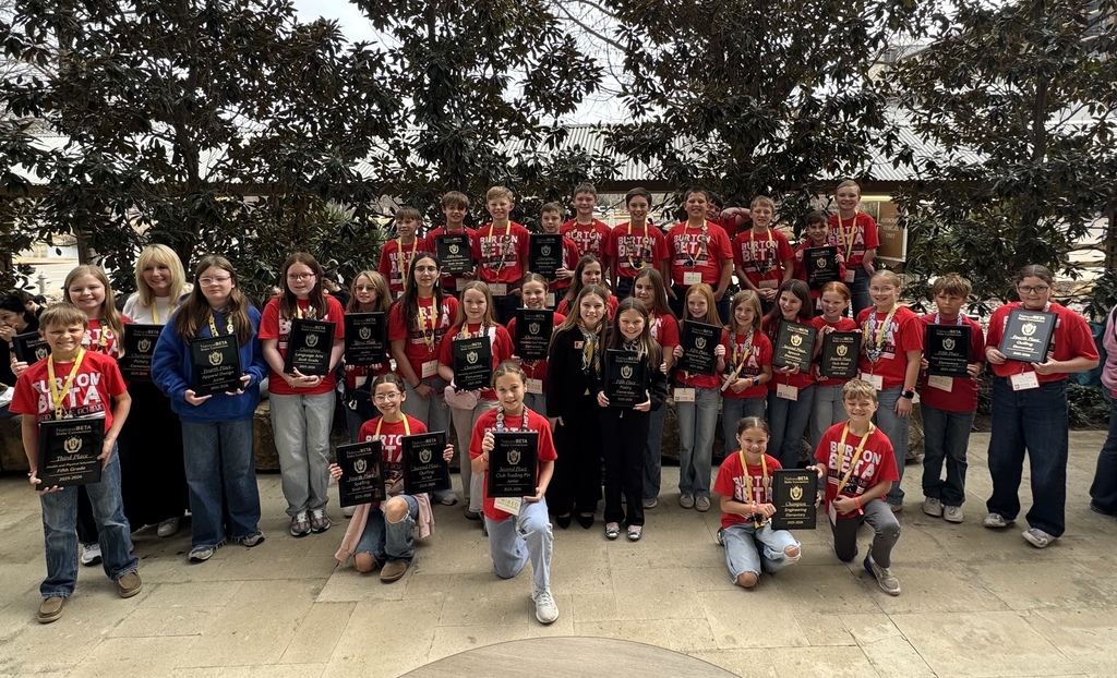 a group of elementary students holding plaques awarded for competitions at Beta state convention