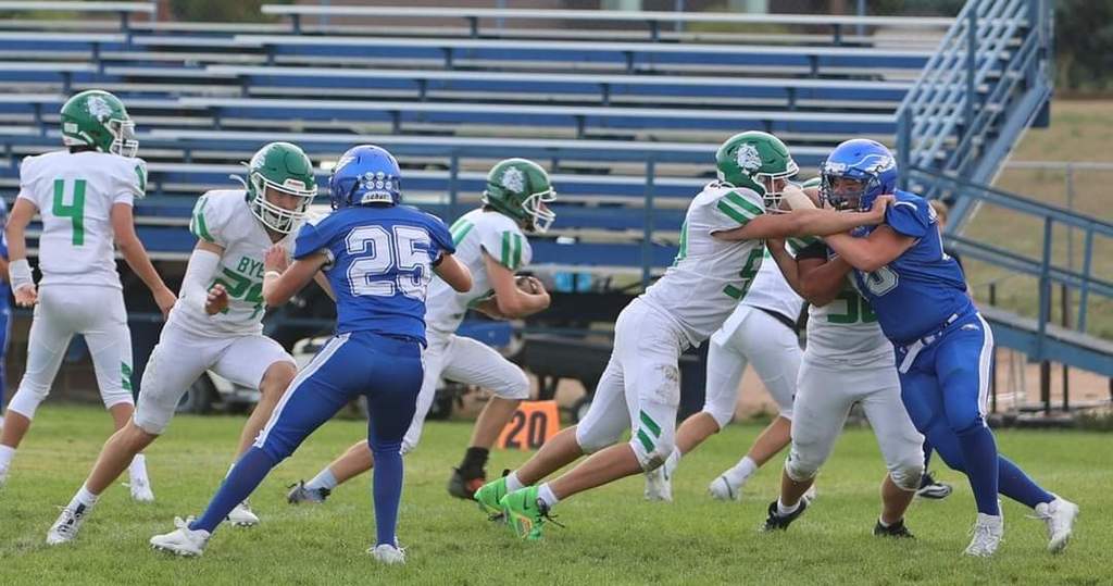 running back runs in in a JV football game