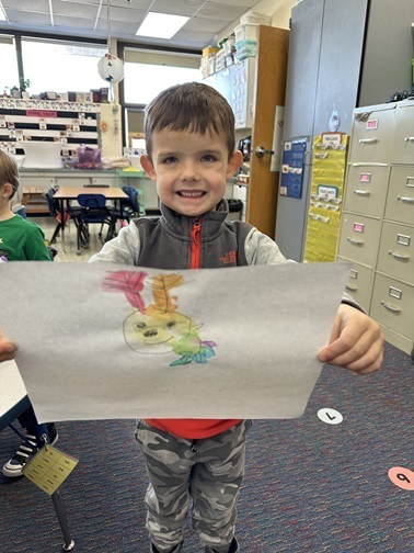 Mary Morgan Student holding up artwork