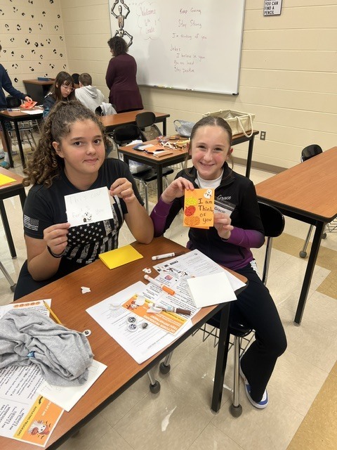 Pictures of Builders Club making cards to be given to children who are in the hospital.
