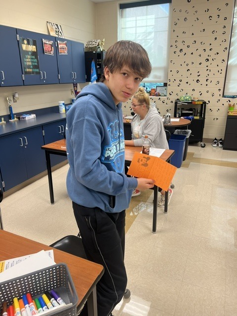 Pictures of Builders Club making cards to be given to children who are in the hospital.