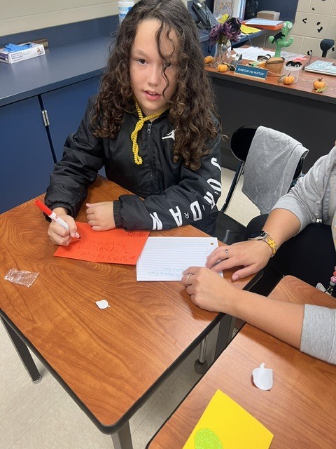 Pictures of Builders Club making cards to be given to children who are in the hospital.