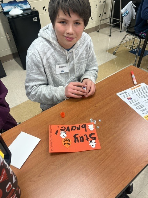 Pictures of Builders Club making cards to be given to children who are in the hospital.