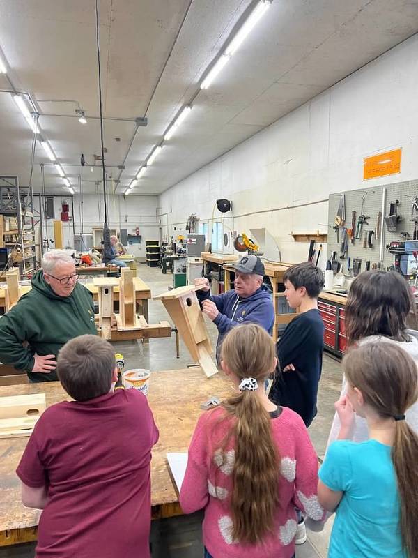 Students learning how to build a birdhouse