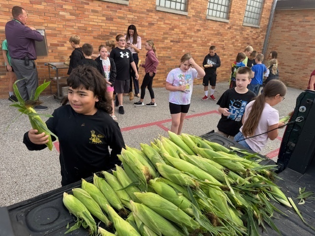Students Shucking Corn
