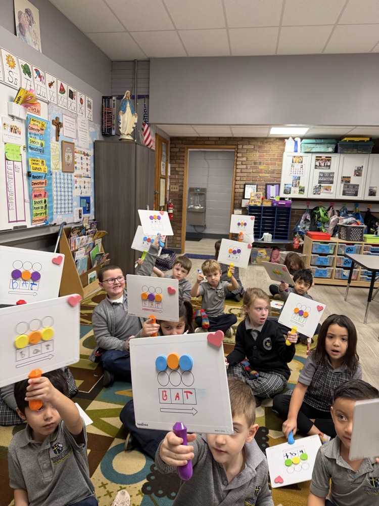 Kindergarten working hard on phonics lesson.