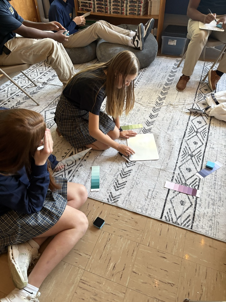 Students discussing what emotion their paint strip colors represent.