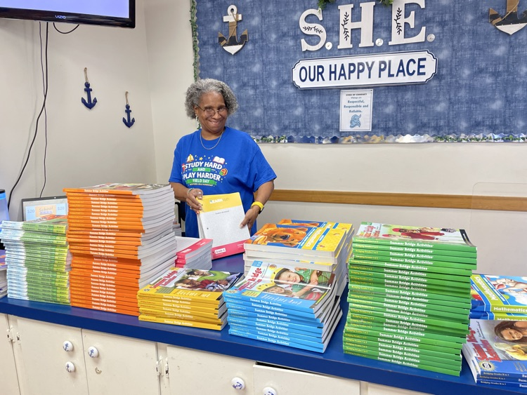 Mrs. McCann with the summer skills books. 
