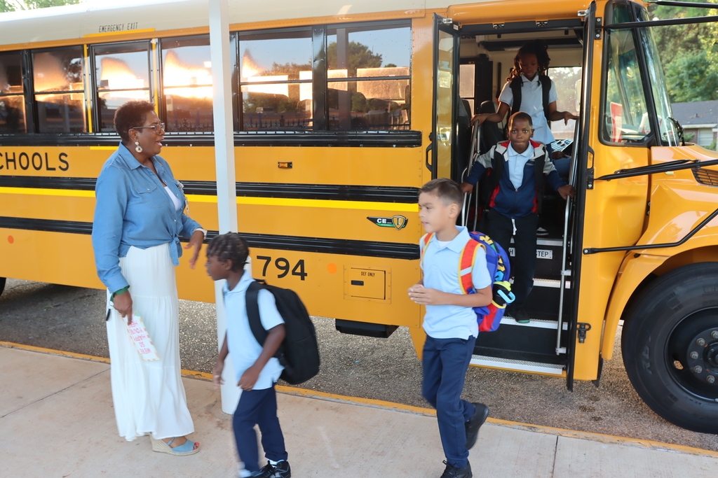 Students getting off of the bus on the first day of school