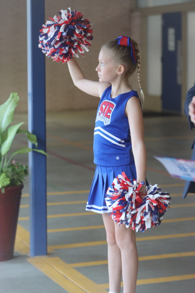Cheerleader at Shreve Island cheers for students arriving for the first day of school