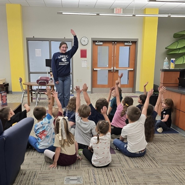 Masters student with younger students in classroom