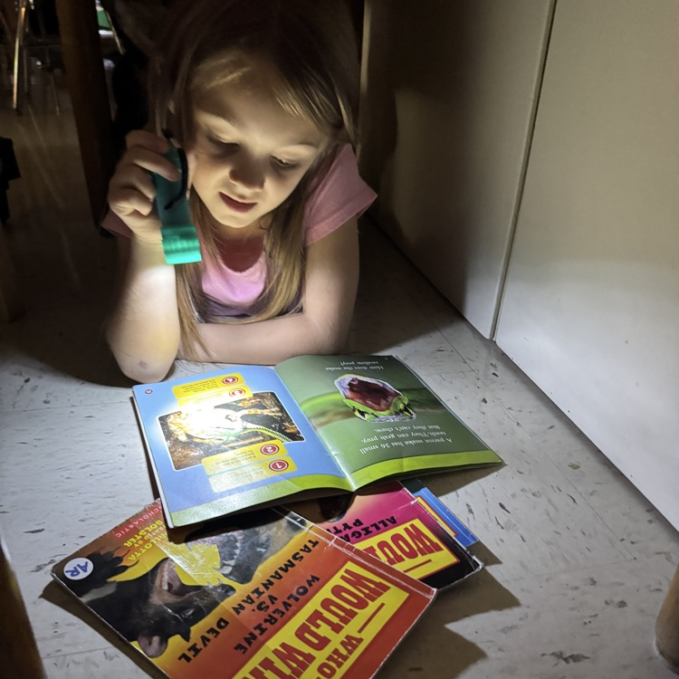 students reading by flashlight