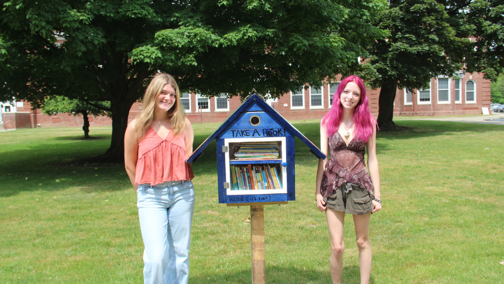 Community Book Box - Civic Readiness Students Smile for photo next to book box
