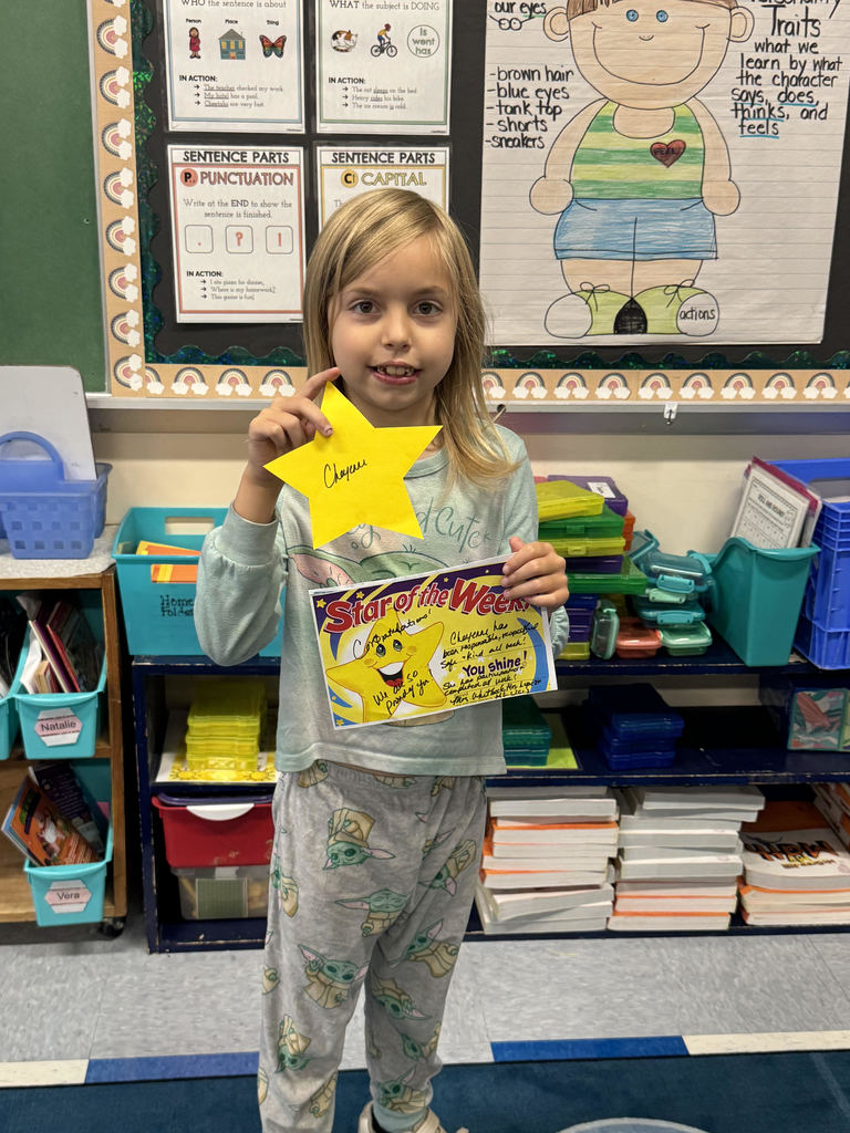 A student standing with an award