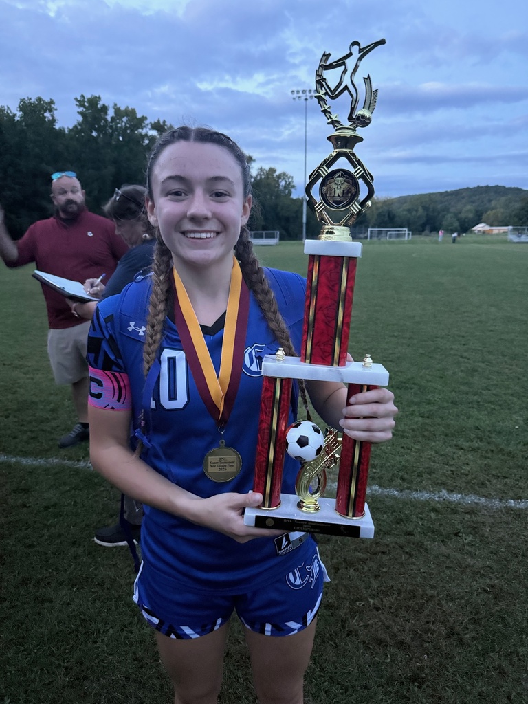 Aria holding the First Place Trophy and her Tournament MVP Medal.
