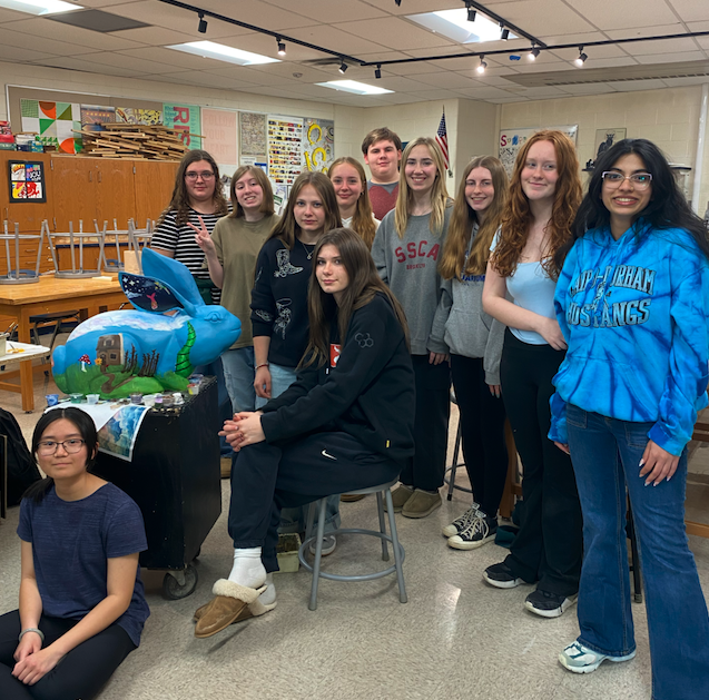 NAHS students smiling with sculpture "Once Upon a Time."