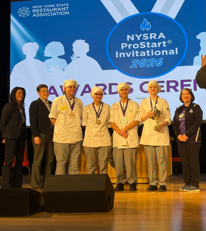 students accepting trophy