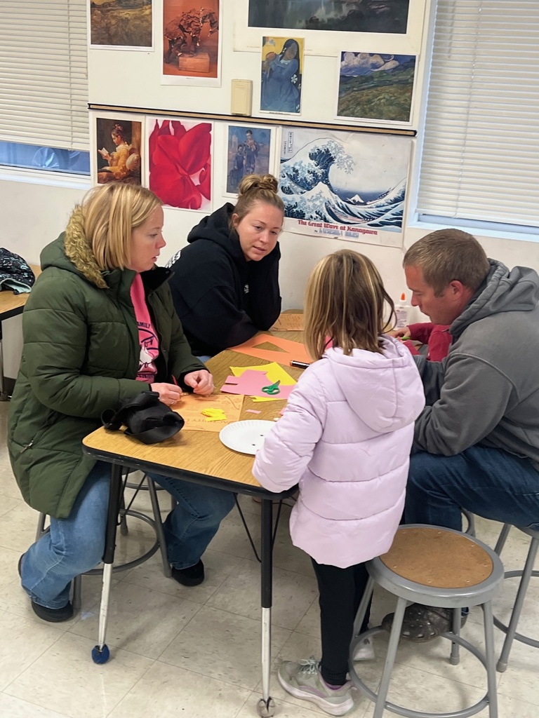 Families building scarecrows 
