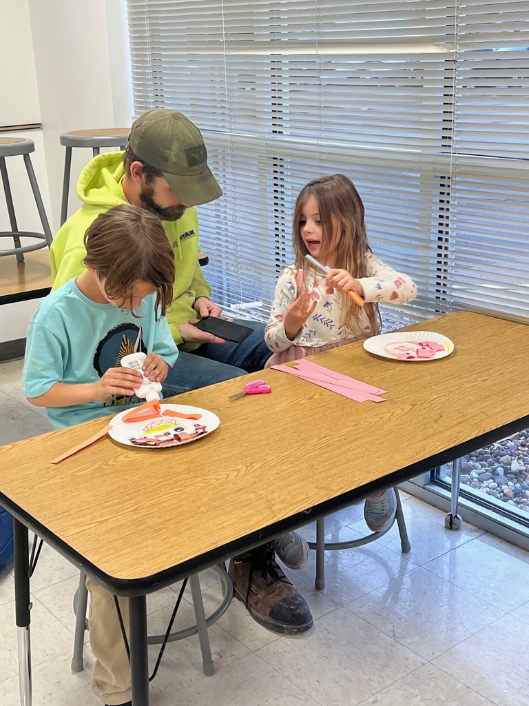 Families building scarecrows 