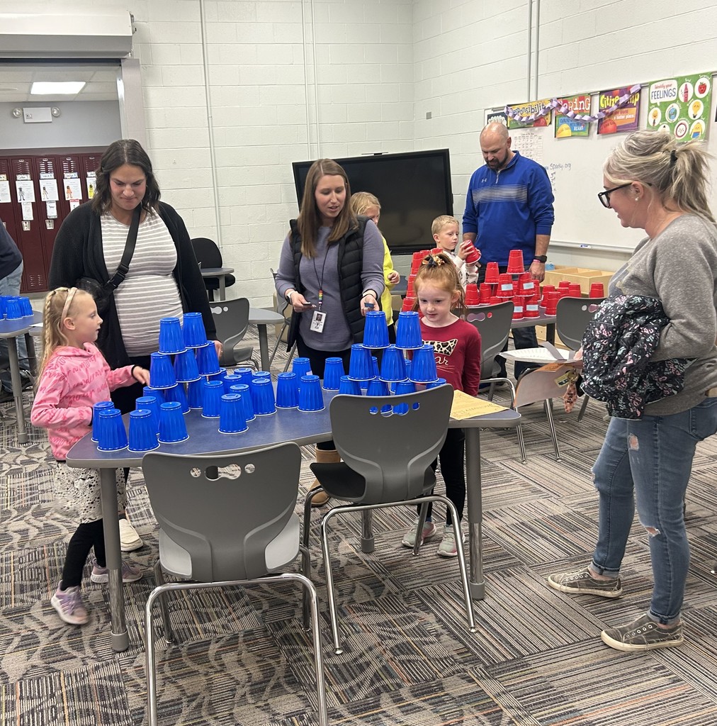 Families building sentences using cups.  