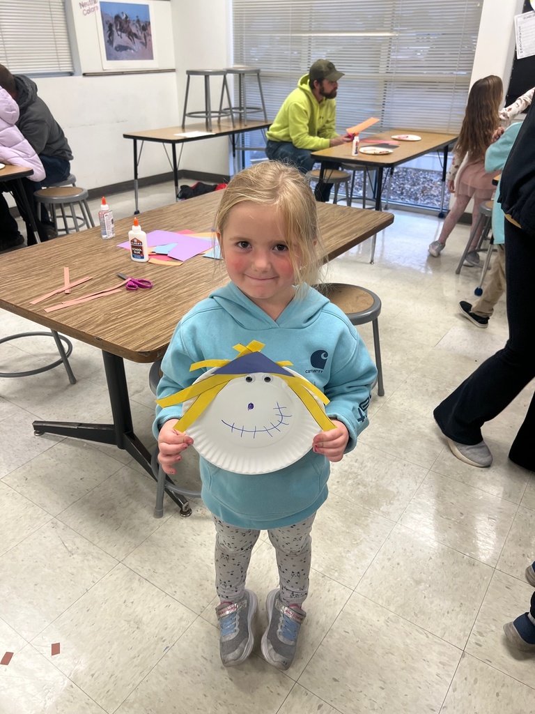 Student showing off their scarecrow 