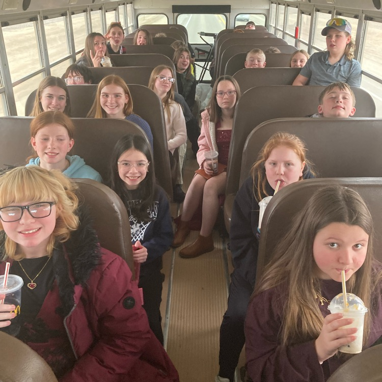Students riding a bus, drinking McDonald’s drinks  