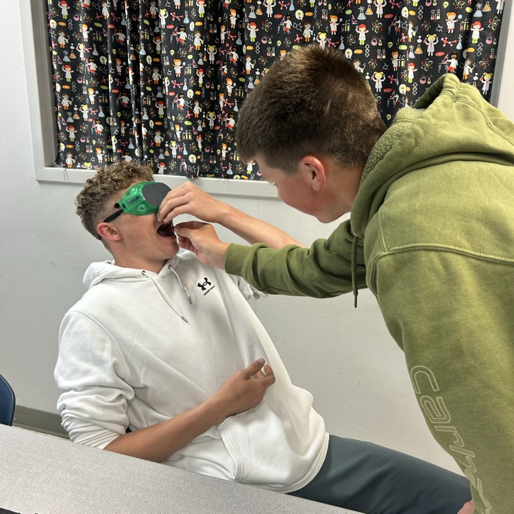 student feeding student 