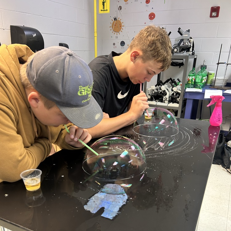 student blowing bubbles