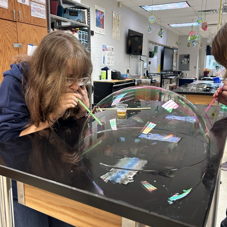 student blowing bubbles