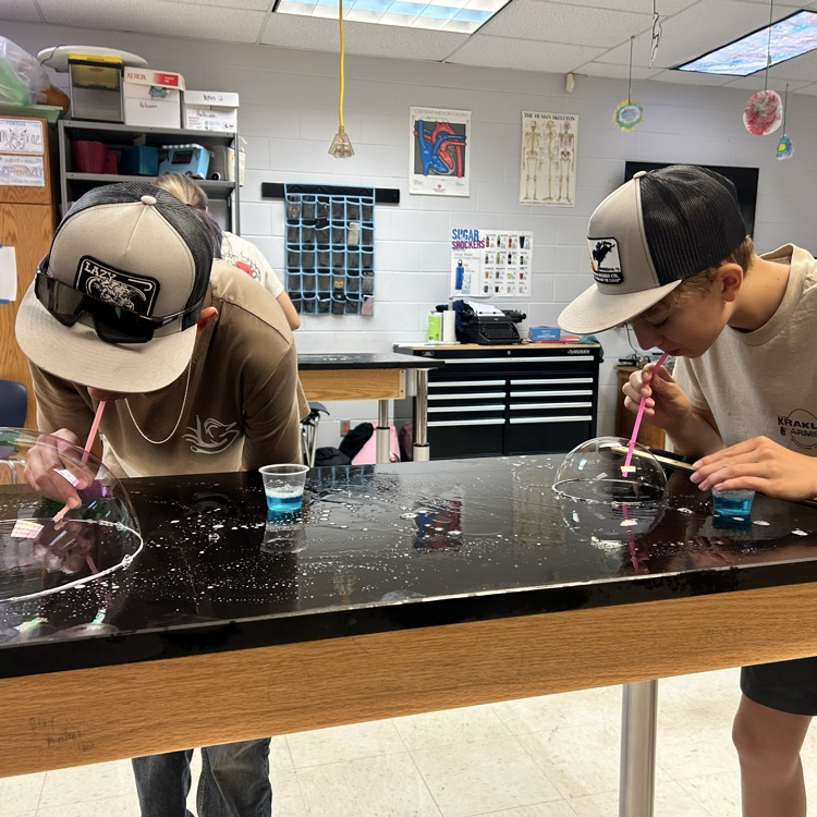 student blowing bubbles