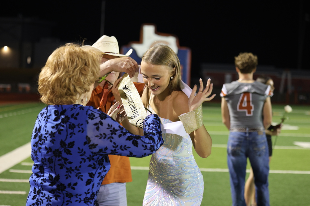 🧡 𝗢𝗡𝗖𝗘 𝗔 𝗛𝗢𝗥𝗡𝗘𝗧, 𝗔𝗟𝗪𝗔𝗬𝗦 𝗔 𝗛𝗢𝗥𝗡𝗘𝗧. 🧡  Friday night’s Homecoming was made extra special by a very special guest — 𝗦𝘁𝗲𝗽𝗵𝗶𝗻𝗮 (𝗡𝗮𝘃𝗿𝗮𝘁𝗶𝗹) 𝗗𝗶𝗗𝗼𝗻𝗮𝘁𝗼, Caldwell High School Class of 1951.  At 94 years young, Stephina traveled all the way from Delaware to come home to Caldwell. She spent the day touring CHS and visiting band rehearsal before making the most of Friday night under the lights.  Under the Friday night lights, she 𝗰𝗼𝗻𝗱𝘂𝗰𝘁𝗲𝗱 𝘁𝗵𝗲 𝗛𝗼𝗿𝗻𝗲𝘁 𝗕𝗮𝗻𝗱 𝗶𝗻 𝘁𝗵𝗲 𝘀𝗰𝗵𝗼𝗼𝗹 𝗮𝗹𝗺𝗮 𝗺𝗮𝘁𝗲𝗿, 𝗽𝗿𝗼𝘂𝗱𝗹𝘆 𝗙𝗟𝗜𝗣𝗣𝗘𝗗 𝘁𝗵𝗲 𝗰𝗼𝗶𝗻 𝗳𝗼𝗿 𝘁𝗵𝗲 𝗼𝗽𝗲𝗻𝗶𝗻𝗴 𝘁𝗼𝘀𝘀, 𝗮𝗻𝗱 𝗵𝗲𝗹𝗽𝗲𝗱 𝗰𝗿𝗼𝘄𝗻 𝗼𝘂𝗿 𝟮𝟬𝟮𝟲 𝗛𝗼𝗺𝗲𝗰𝗼𝗺𝗶𝗻𝗴 𝗤𝘂𝗲𝗲𝗻.   Seventy-five years after graduating from CHS, Stephina reminded us that the years may pass and generations may change, but 𝒚𝙤𝒖 𝒏𝙚𝒗𝙚𝒓 𝒓𝙚𝒂𝙡𝒍𝙮 𝙨𝒕𝙤𝒑 𝒃𝙚𝒊𝙣𝒈 𝒂 𝑯𝙤𝒓𝙣𝒆𝙩.  Thank you for coming home, Stephina. 𝗧𝗵𝗶𝘀 𝗶𝘀 𝗼𝗻𝗲 𝗛𝗼𝗺𝗲𝗰𝗼𝗺𝗶𝗻𝗴 𝘄𝗲 𝘄𝗼𝗻’𝘁 𝘀𝗼𝗼𝗻 𝗳𝗼𝗿𝗴𝗲𝘁. #CaldwellProud #CaldwellISD