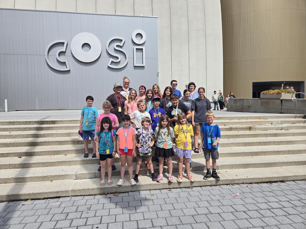 students gathered for a photo from their trip to COSI