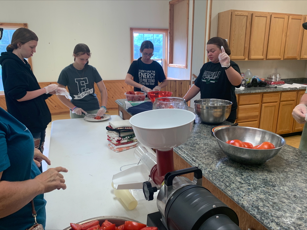 Students learn to can tomatoes at the Summer School Cooking and Canning Camp