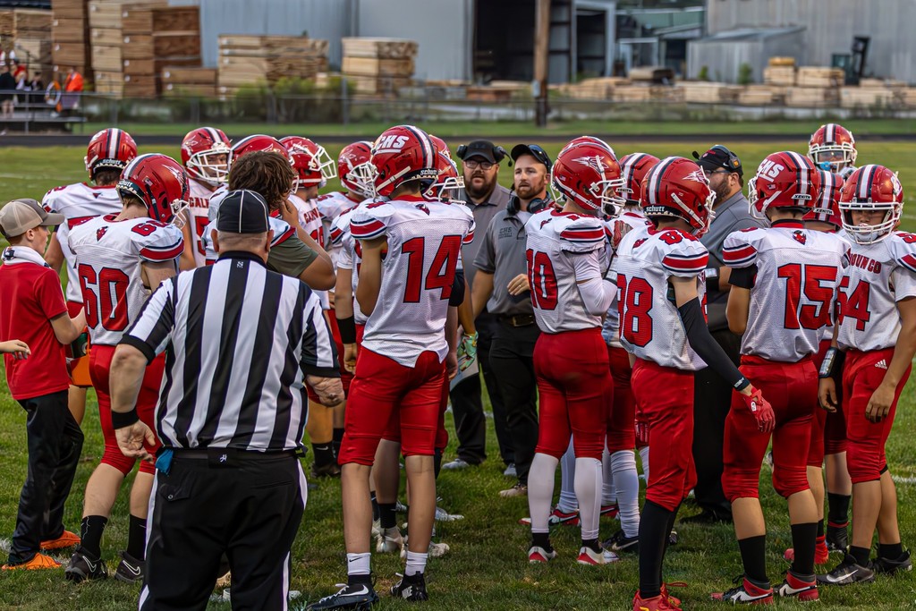 CHS Football in game huddle.