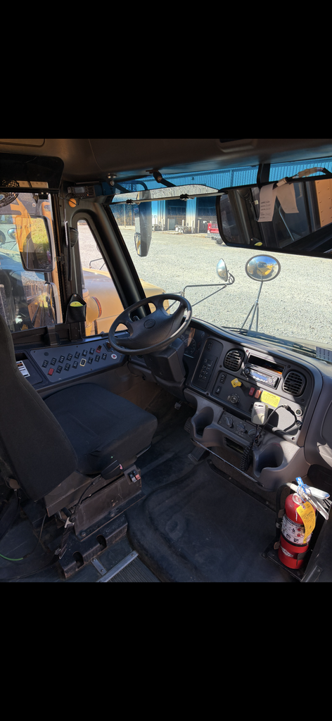 for surplus Bus 29 2011 Thomas FRHT picture shows inside of the bus, driver's seat, steering wheel, dash and window. 