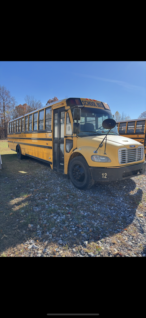 For surplus Bus 12 Thomas Freightliner picture is the right side view of the school bus, showing the front and right side including the door