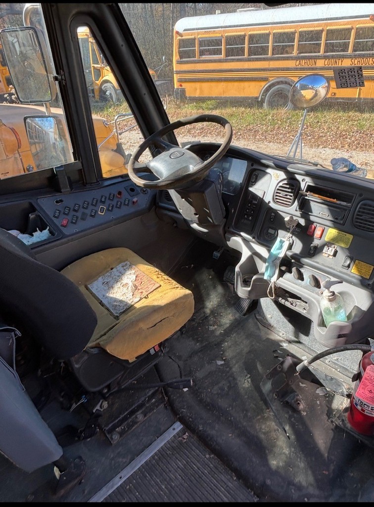 Inside view of bus 4 driver's seat, steering wheel and dash