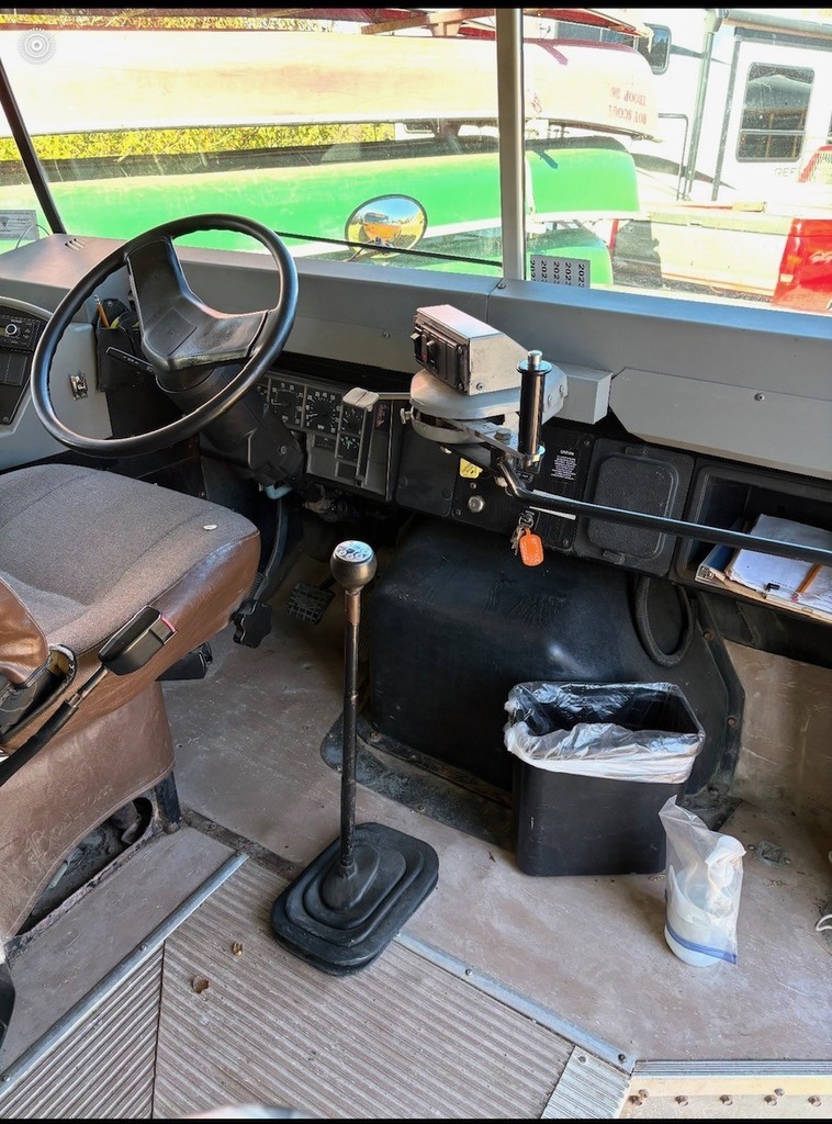 Inside picture of bus 28 driver's seat, steering wheel, dash, windshield