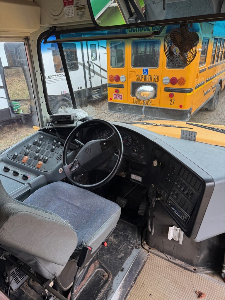 Inside view of bus 3 driver's seat, steering wheel, dashboard and windshield