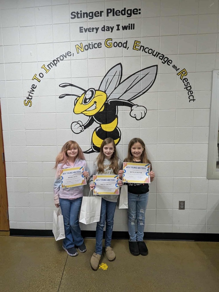 three students with certificates 