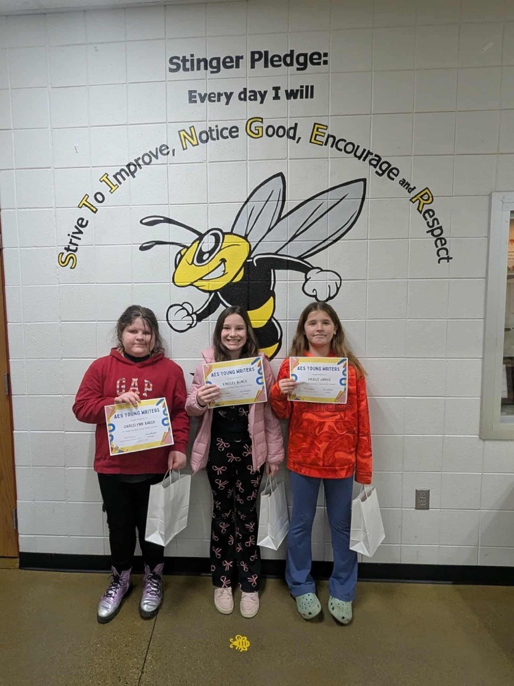 three students with certificates 