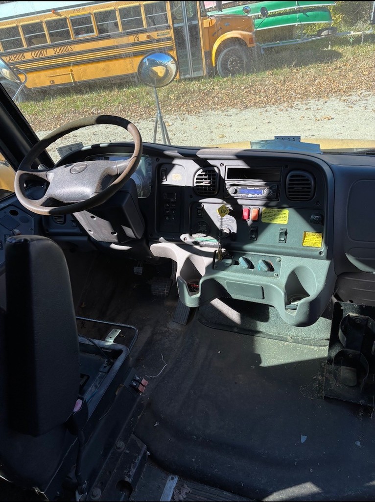 Inside view of bus 3 driver seat steering wheel, windshield and dash
