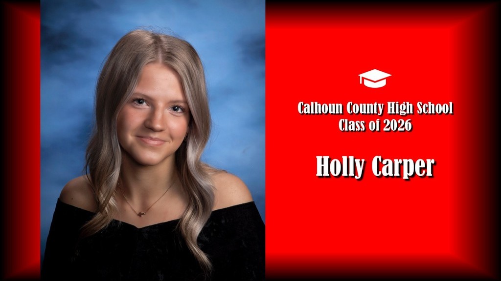 A formal senior portrait layout featuring a student with long wavy hair, wearing a black off-the-shoulder top and a small necklace, posed against a blue studio background on the left. The right side shows a bright red panel with a graduation cap icon and white text that reads “Calhoun County High School Class of 2026” and the name “Holly Carper” in large bold letters.