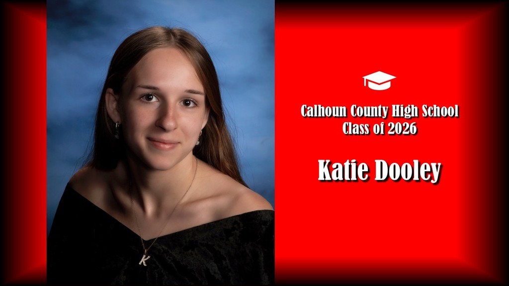 A formal senior portrait layout featuring a student with long straight hair, wearing a black off-the-shoulder top and a necklace, posed against a blue studio background on the left. The right side displays a bright red panel with a graduation cap icon and white text that reads “Calhoun County High School Class of 2026” and the name “Katie Dooley” in large bold letters.