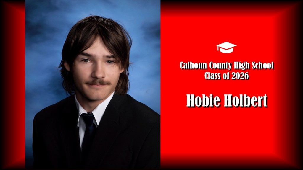 A formal senior portrait layout featuring a student with medium-length straight hair and light facial hair, wearing a black suit jacket, white shirt, and dark tie, posed against a blue studio background on the left. The right side displays a bright red panel with a graduation cap icon and white text that reads “Calhoun County High School Class of 2026” and the name “Hobie Holbert” in large bold letters.