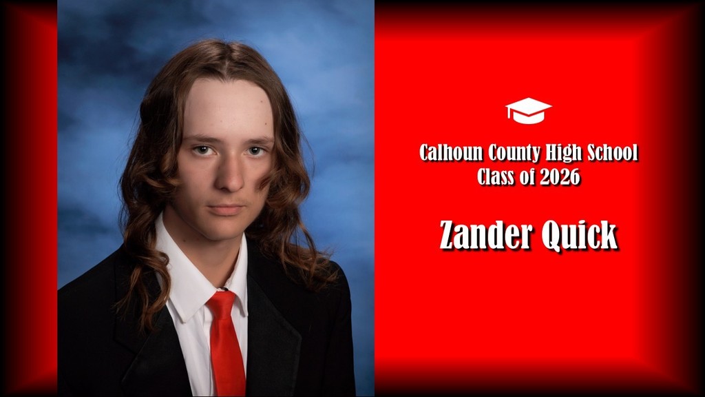 A formal senior portrait layout featuring a student with long, loosely curled hair, wearing a black suit jacket, white shirt, and red tie, posed against a blue studio background on the left. The right side displays a bright red panel with a graduation cap icon and white text that reads “Calhoun County High School Class of 2026” and the name “Zander Quick” in large bold letters.