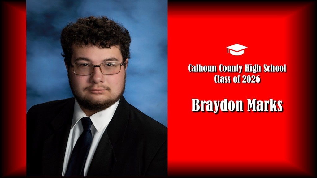A formal senior portrait layout featuring a student with short curly hair and glasses, wearing a black suit jacket, white shirt, and dark tie, posed against a blue studio background on the left. The right side displays a bright red panel with a graduation cap icon and white text that reads “Calhoun County High School Class of 2026” and the name “Braydon Marks” in large bold letters.