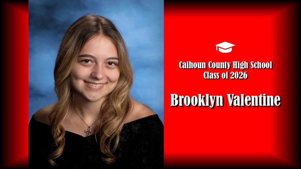 A formal senior portrait layout featuring a student with long, softly curled light brown hair, wearing a black off-the-shoulder top and a necklace with a cross pendant, posed against a blue studio background on the left. The right side displays a bright red panel with a graduation cap icon and white text that reads “Calhoun County High School Class of 2026” and the name “Brooklyn Valentine” in large bold letters.