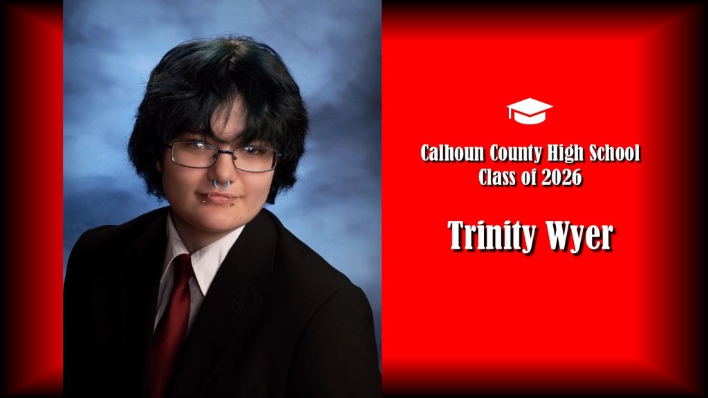 A formal senior portrait layout featuring a student with short dark hair, wearing glasses and a black suit jacket with a white shirt and red tie, posed against a blue studio background on the left. The right side displays a bright red panel with a graduation cap icon and white text that reads “Calhoun County High School Class of 2026” and the name “Trinity Wyer” in large bold letters.