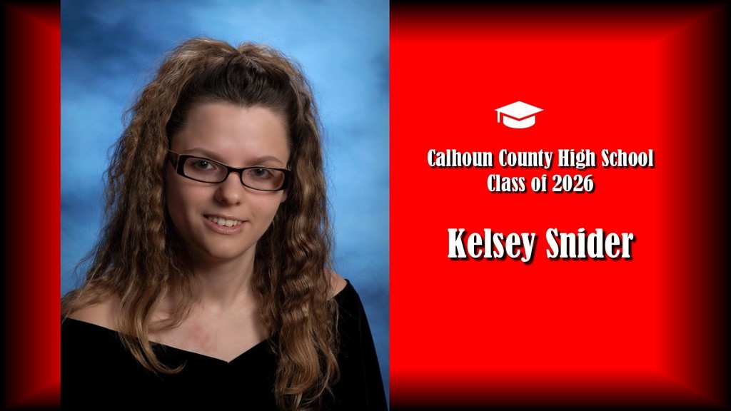  A formal senior portrait layout featuring a student with long curly hair pulled half up, wearing glasses and a black off-the-shoulder top, posed against a blue studio background on the left. The right side displays a bright red panel with a graduation cap icon and white text that reads “Calhoun County High School Class of 2026” and the name “Kelsey Snider” in large bold letters.